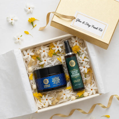 Shesha Ayurveda Glow & Stay Fresh Kit overhead flat lay in gold gift box with Parijatham flowers and marigold petals