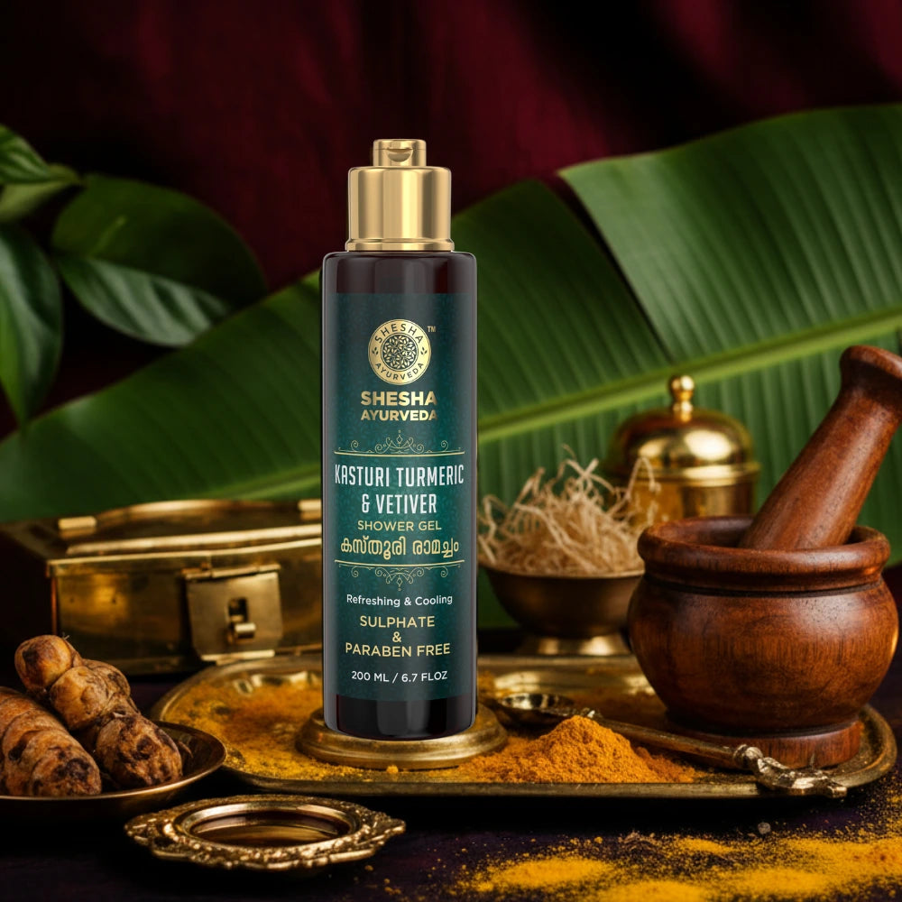 A pump bottle of Shesha Ayurveda Kasturi Turmeric & Vetiver Shower Gel with product information and branding visible against a blurred background.


